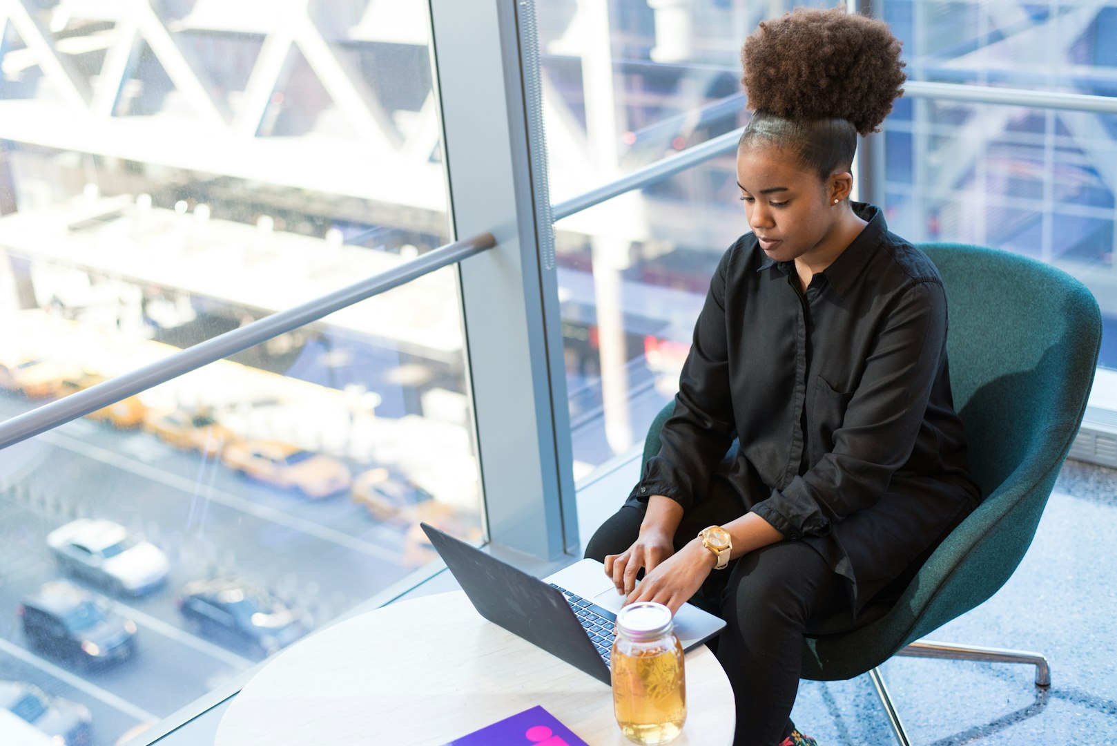 wOMAN HOLDING TABLET WITH CARTOON ICONS IN A CIRCLE SURROUNDING HER