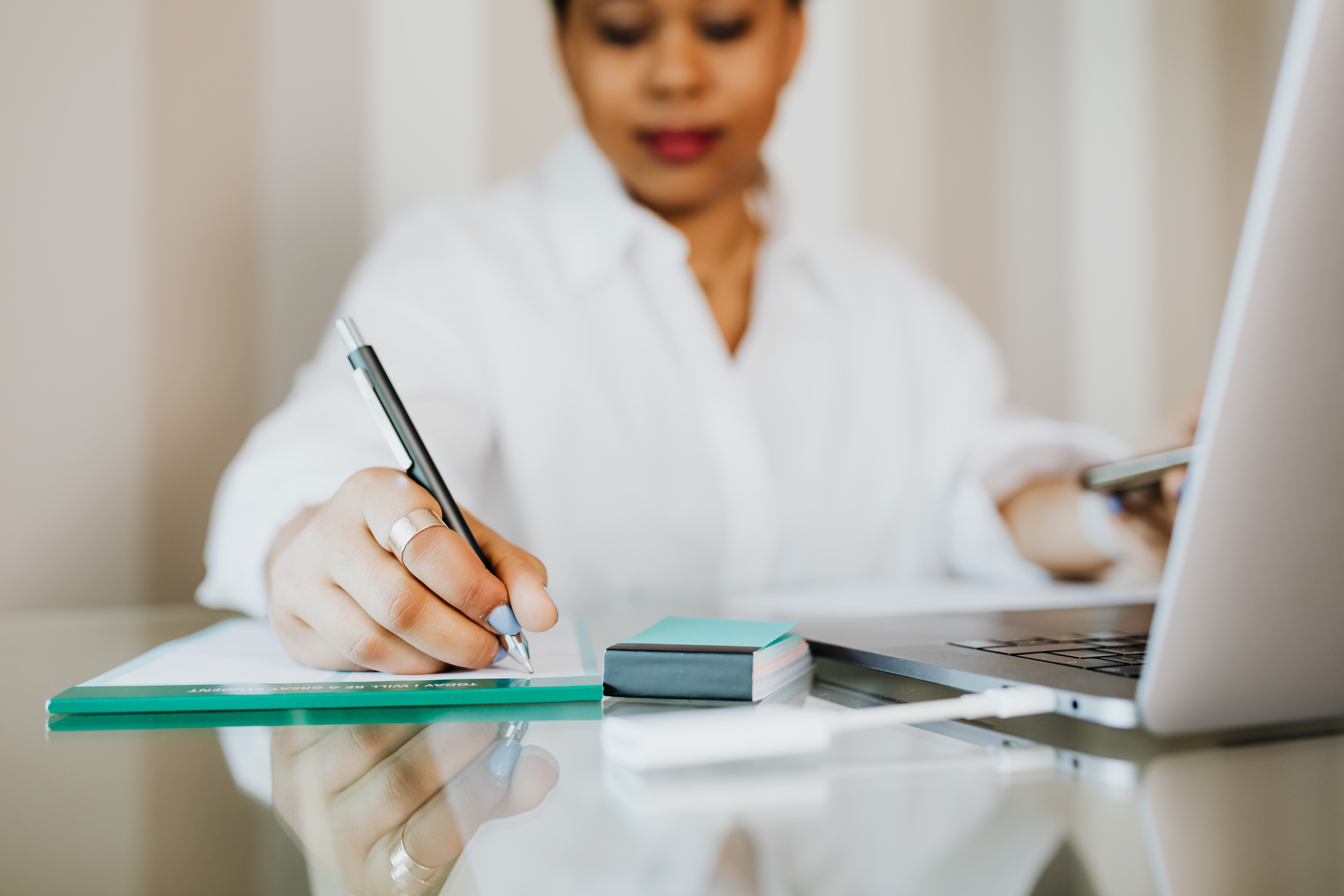 Burnout Interactive Journal- Photo of woman writing in a journal.